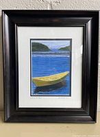 Framed and matted print showing image, signature, frame
