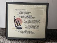 Front view of framed cross-stitch showing design and frame