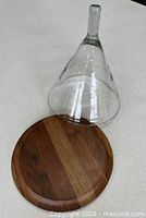 glass dome and wooden base separated showing interior and wood grain
