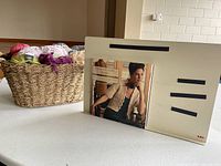 Pattern holder with book displayed, basket of yarn behind