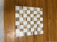 Top view of onyx chess board showing beige and amber squares
