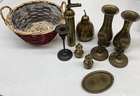 All items in lot laid out including basket, brass pieces, silver candlestick
