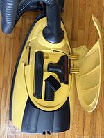 Open accessory compartment showing attachments inside lid