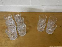 All ten clear cut crystal tumbler glasses grouped on tabletop