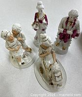 All four porcelain figurines grouped together