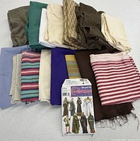 Overview of pattern envelope and stacked assorted fabrics