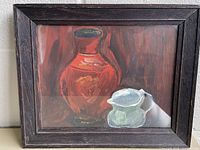 framed still life painting showing red and pale jugs