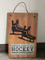 Front view of the wood plaque showing graphic, text, and hanger