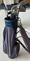 Full view of navy/blue golf bag with TaylorMade clubs inside