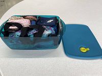 Overall lot with Tupperware container open showing beverage sleeves inside