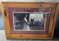 Full view of framed print showing artwork, matting, glass, and carved knotty pine frame