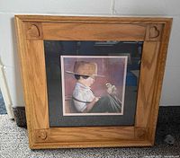 Oak frame with carved hearts and matted boy-with-chick print