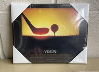 Front view of sealed plaque showing design, title, quote, packaging corners and shrink wrap