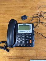 Top view of VTech CD1281 phone base, handset, coiled cord and power adapter