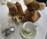 Group shot: teacup, saucer, bagged strainers, two koala cozies