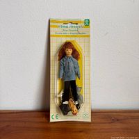 Front view of packaged Erna Meyer flexible doll with three dog figures
