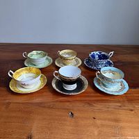 Front view of six assorted teacup and saucer sets