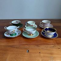 All six teacup and saucer sets on table front view