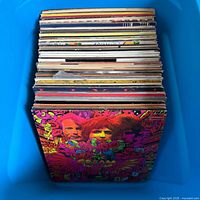 Top view of stacked LP records inside blue bin