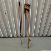 Full view of both rod sections beside wooden case