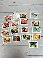 Spread of assorted Disney collector cards on floor