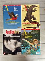Four magazine covers: bird, lizard, female portrait, swimmer