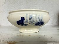Side view showing blue transfer animals inside landscape on bowl exterior