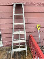 Front view of 6-ft wooden ladder leaning against wall