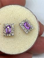 Front view showing amethyst centers and diamond halos