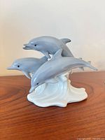 Porcelain trio dolphin figurine close-up