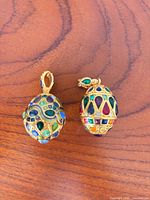 Front view of both Joan Rivers egg pendants showing overall design and colour