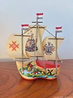 Wooden Dutch clog ship souvenir with cream sails, printed galleon and coat of arms graphics