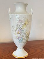 Full view of vase showing shape, handles, floral and butterfly design