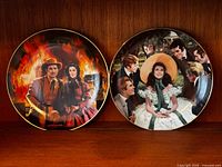 Two decorative Gone With The Wind plates on shelf showing front artwork
