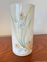 Full view of cylindrical vase showing floral design