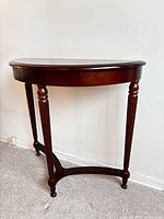 Full front view of mahogany half moon console table