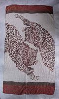 Full view of scarf showing twin leopard pattern and border