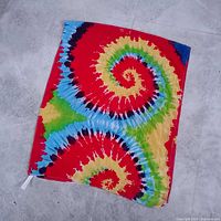 Entire scarf laid flat showing full spiral tie-dye pattern
