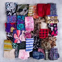 Grid layout of dozens of patterned and solid scarves showing variety of colours and sizes