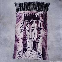 Full view of front side of scarf showing portrait design and fringe