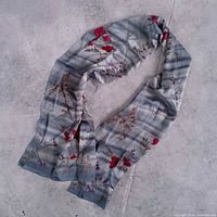 Full view of blue floral Laura Ashley scarf laid flat