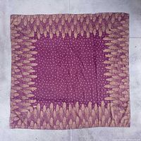 Full view of purple and gold square scarf laid flat