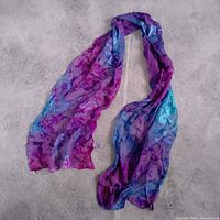 Full view of sheer floral scarf laid flat showing size and pattern