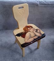 Full view of wooden chair showing painted seat and carved backrest