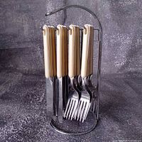 Knives and forks hanging on chrome stand
