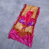 Full view of crinkled pink, gold and purple silk scarf