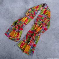Full view of long multicolor patchwork scarf laid out