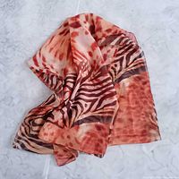 Full view of silk scarf laid out showing overall pattern and dimensions