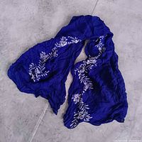 Full view of blue scarf with white floral pattern