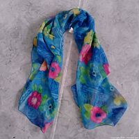Full view of blue floral scarf laid flat in loop